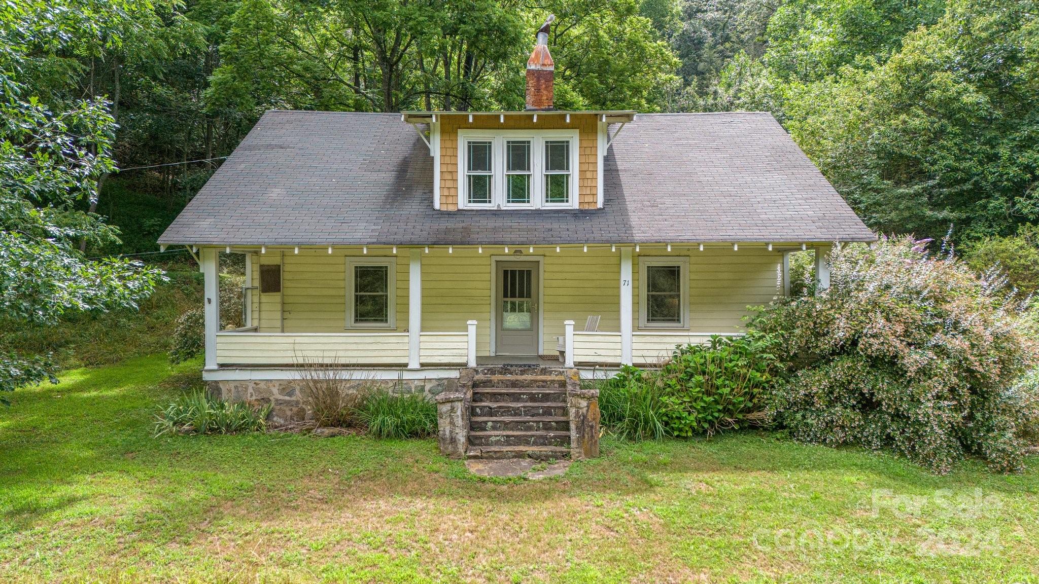 71 Persimmon Lane Canton, NC 28716 - Photo 2 of 41 a front view of a house with a garden