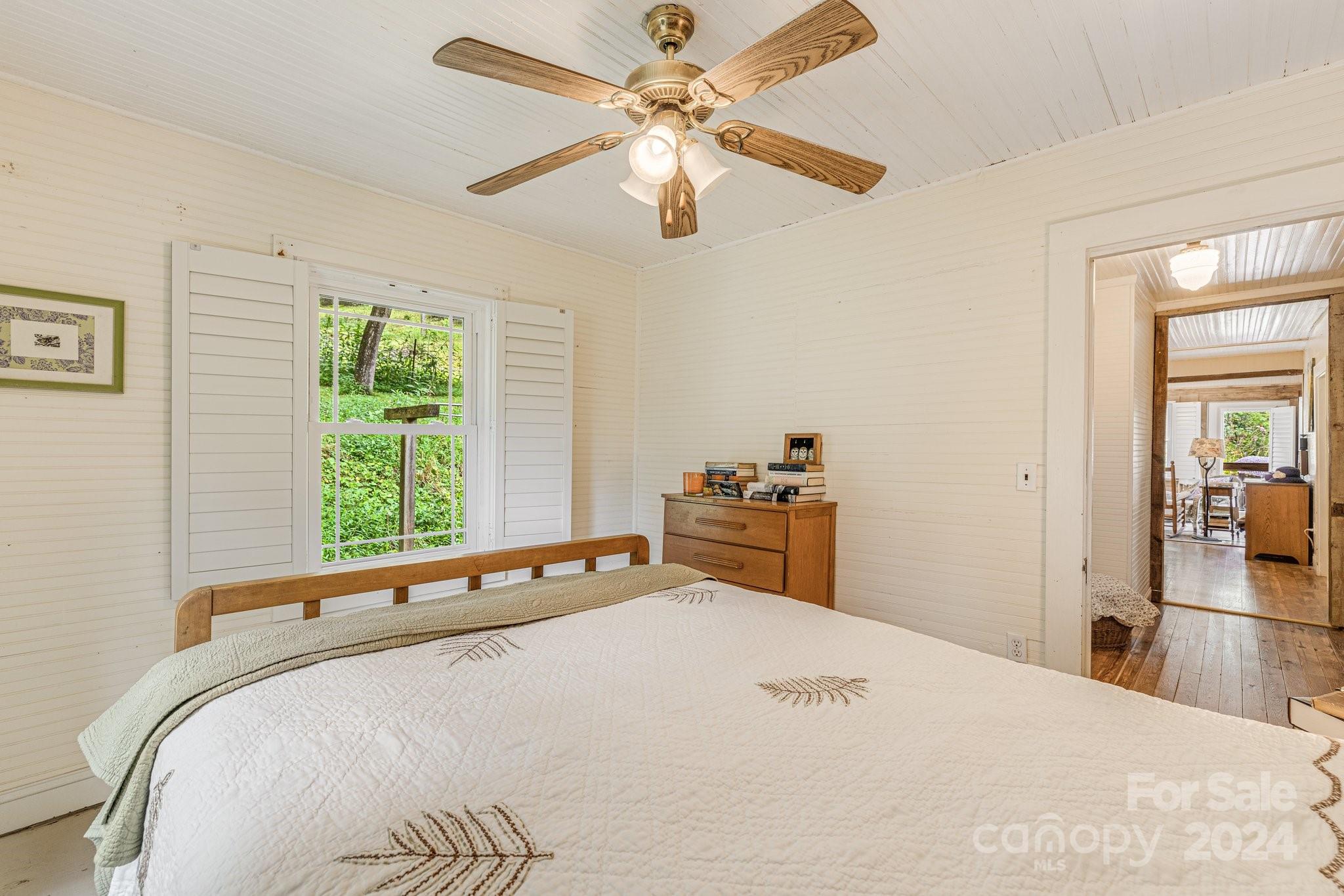 71 Persimmon Lane Canton, NC 28716 - Photo 21 of 41 a bedroom with a bed and a large window