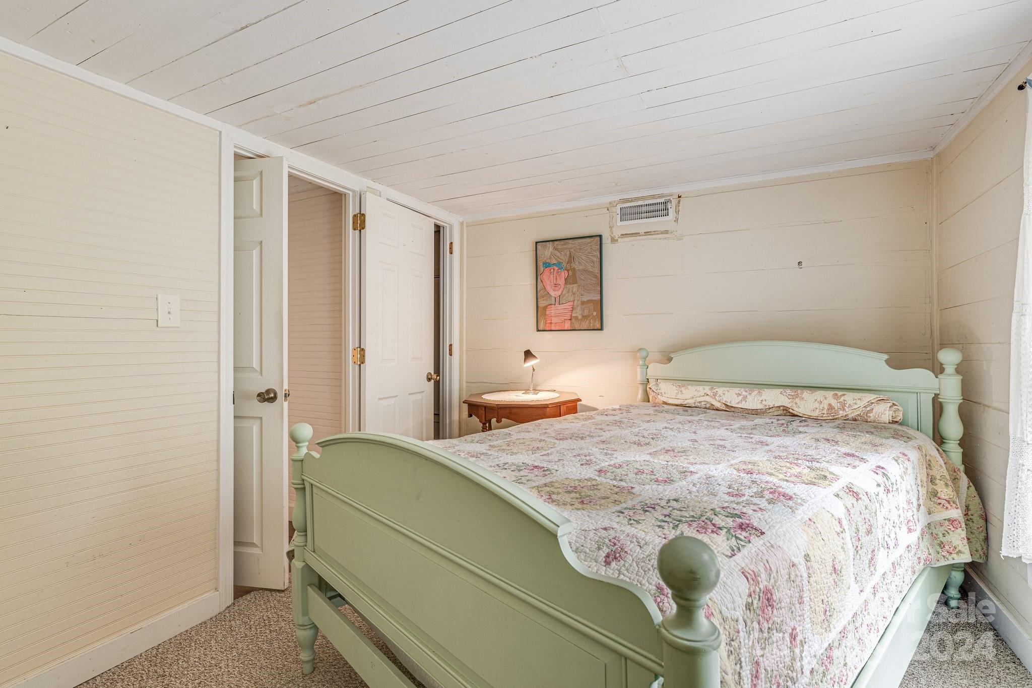 71 Persimmon Lane Canton, NC 28716 - Photo 24 of 41 a bedroom with a bed and a window