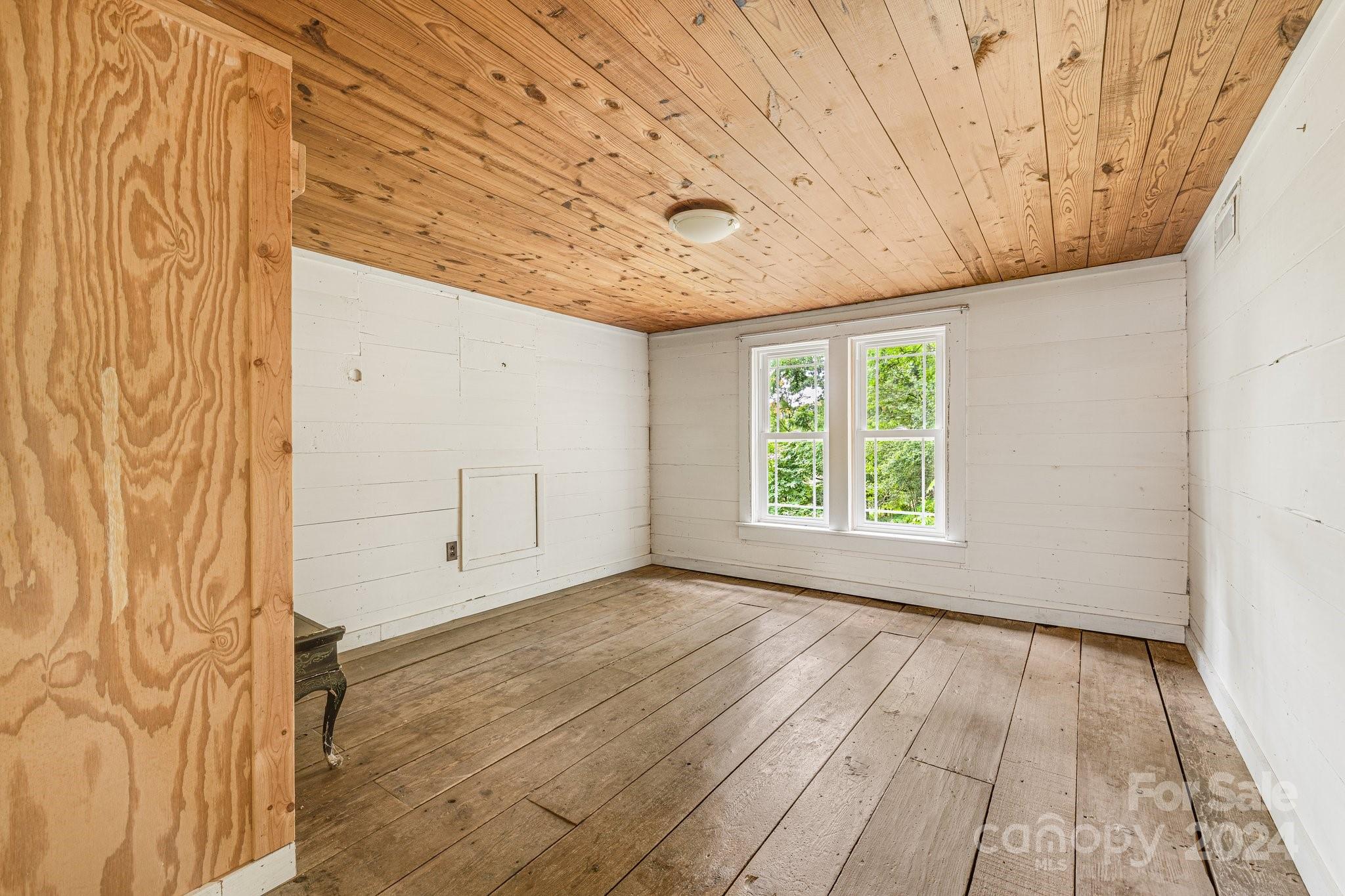 71 Persimmon Lane Canton, NC 28716 - Photo 25 of 41 a view of a room with wooden floor and windows