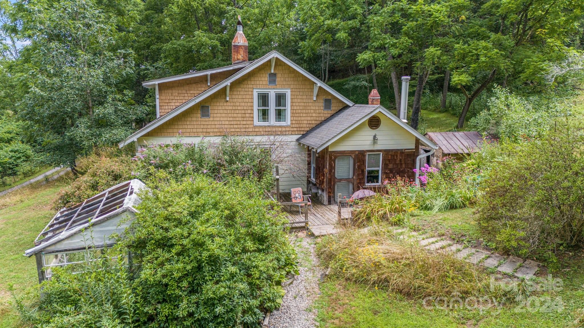 71 Persimmon Lane Canton, NC 28716 - Photo 32 of 41 a view of a house with yard and sitting area