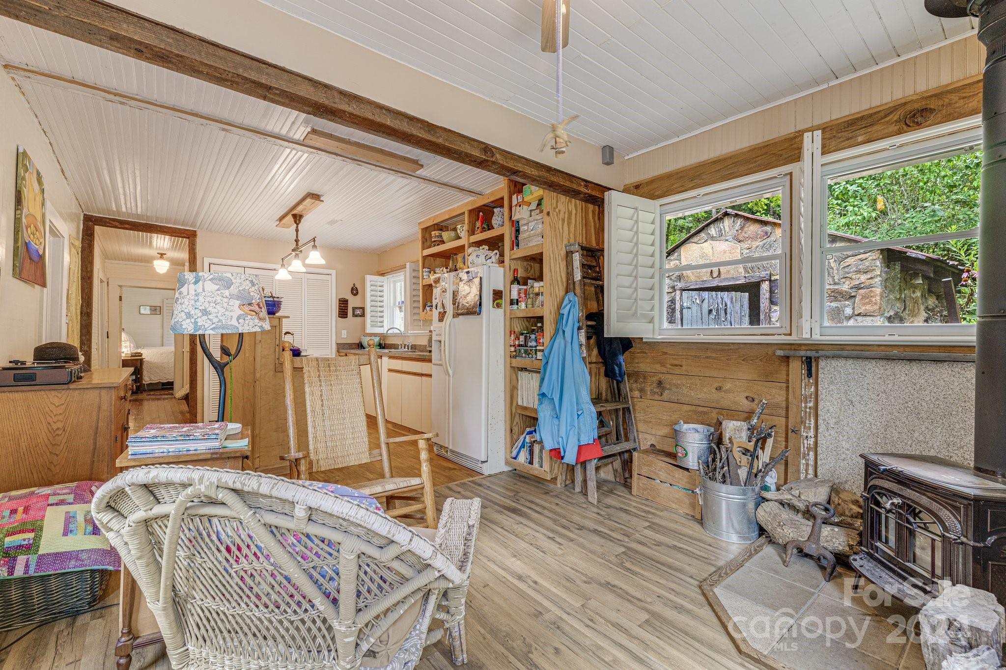71 Persimmon Lane Canton, NC 28716 - Photo 4 of 41 a bed room with a bed window and a chandelier