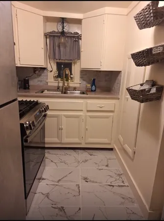 a kitchen with a sink cabinets and appliances