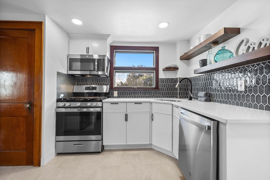 58 Watervale Road Medford, MA 02155 - Photo 3 of 41 a kitchen with stainless steel appliances a stove a sink and a refrigerator