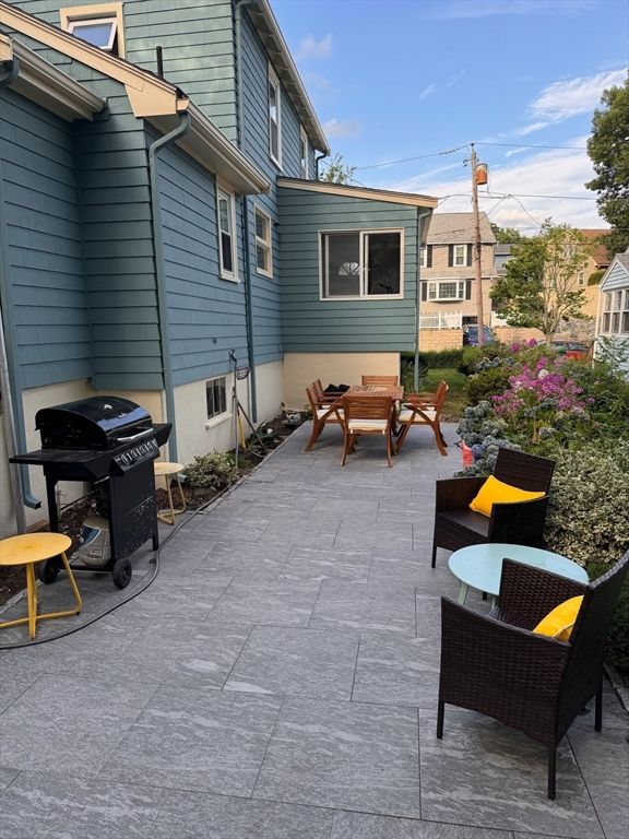 58 Watervale Road Medford, MA 02155 - Photo 36 of 41 a backyard of a house with outdoor seating