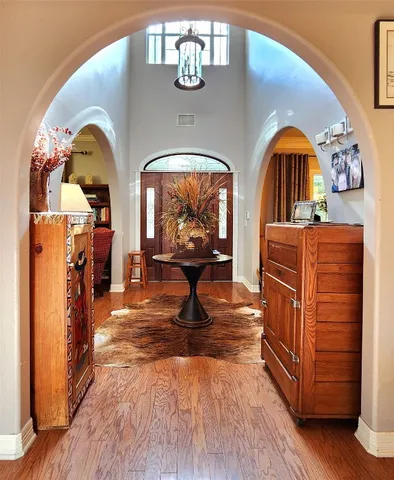 a living room with furniture a piano and wooden floor
