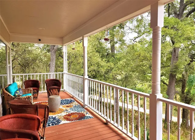 a view of a chair and tables in the balcony