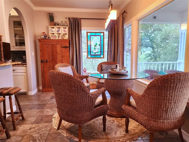 a dining room with furniture and window