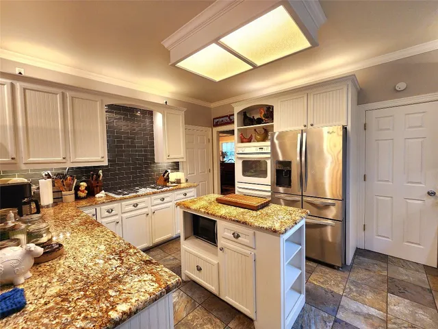 a kitchen with a refrigerator stove and sink