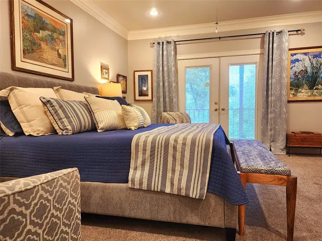 a bedroom with a bed and glass window