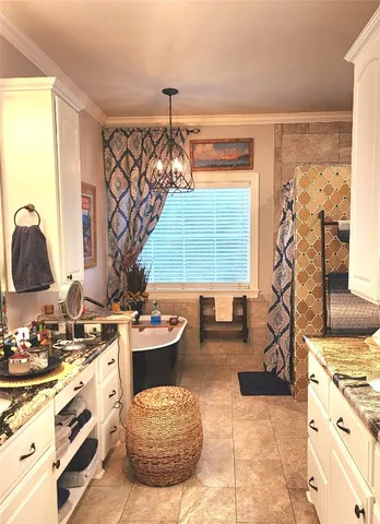 a bathroom with a sink vanity granite tub and shower
