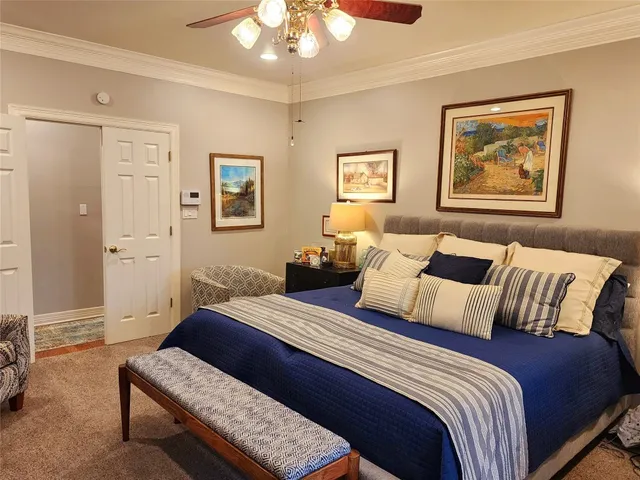 a bedroom with bed and painting on the wall