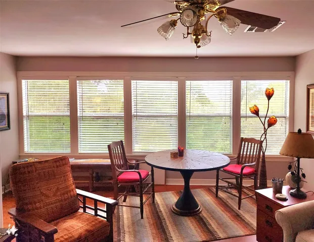 a living room with furniture and floor to ceiling windows
