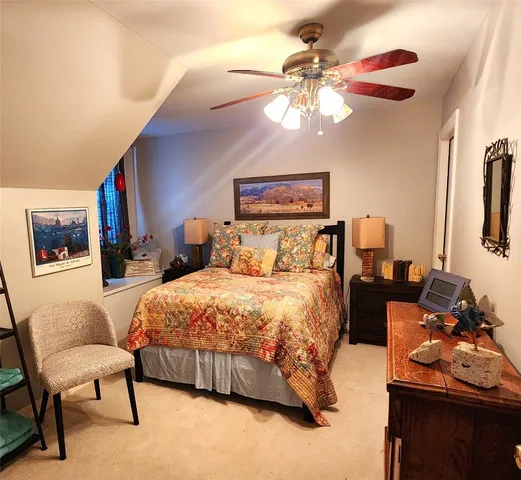 a bathroom with a granite countertop toilet a sink and a mirror