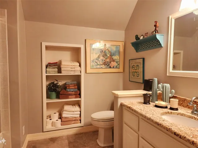 a view of a big yard with plants and large trees