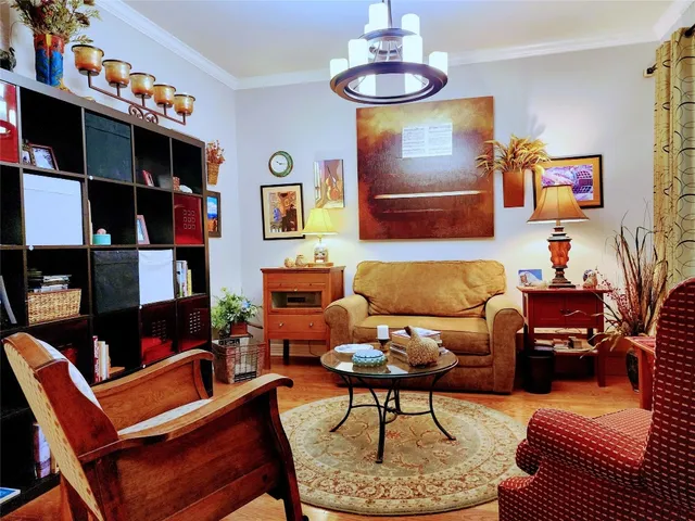 a living room with furniture and a bookshelf