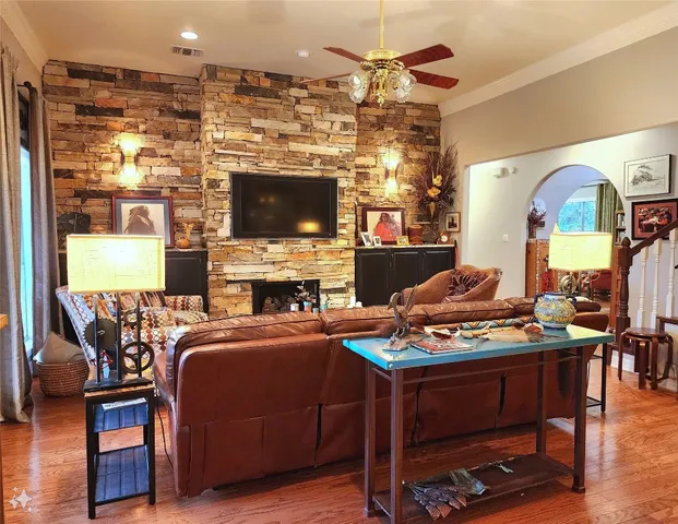 a living room with fireplace furniture and a flat screen tv