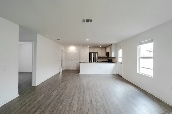 a view of kitchen with refrigerator and window