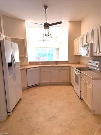 a large kitchen with stainless steel appliances granite countertop a sink and cabinets