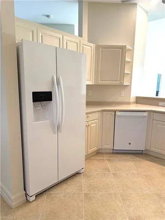 a white refrigerator freezer sitting in a kitchen