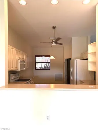 a view of a living room with a refrigerator