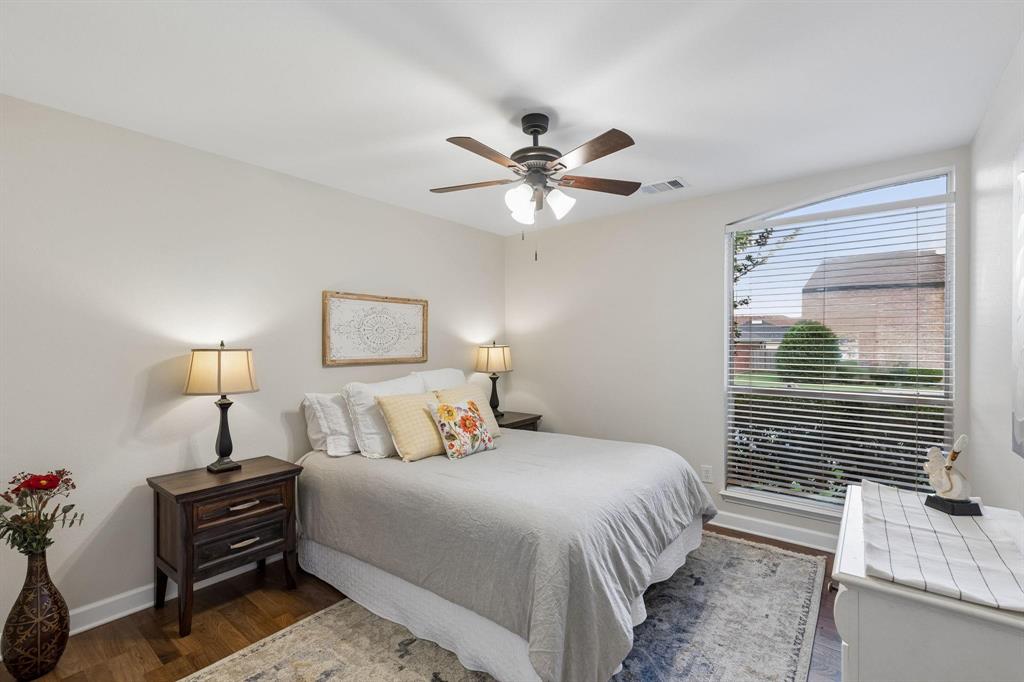 915 Rutgers Court Allen, TX 75002 - Photo 24 of 39 a bedroom with a bed and a chandelier