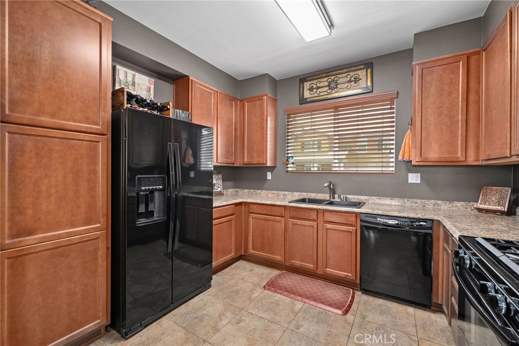33942 Telstar Road Yucaipa, CA 92399 - Photo 14 of 40 a kitchen with granite countertop stainless steel appliances a refrigerator stove top oven and sink