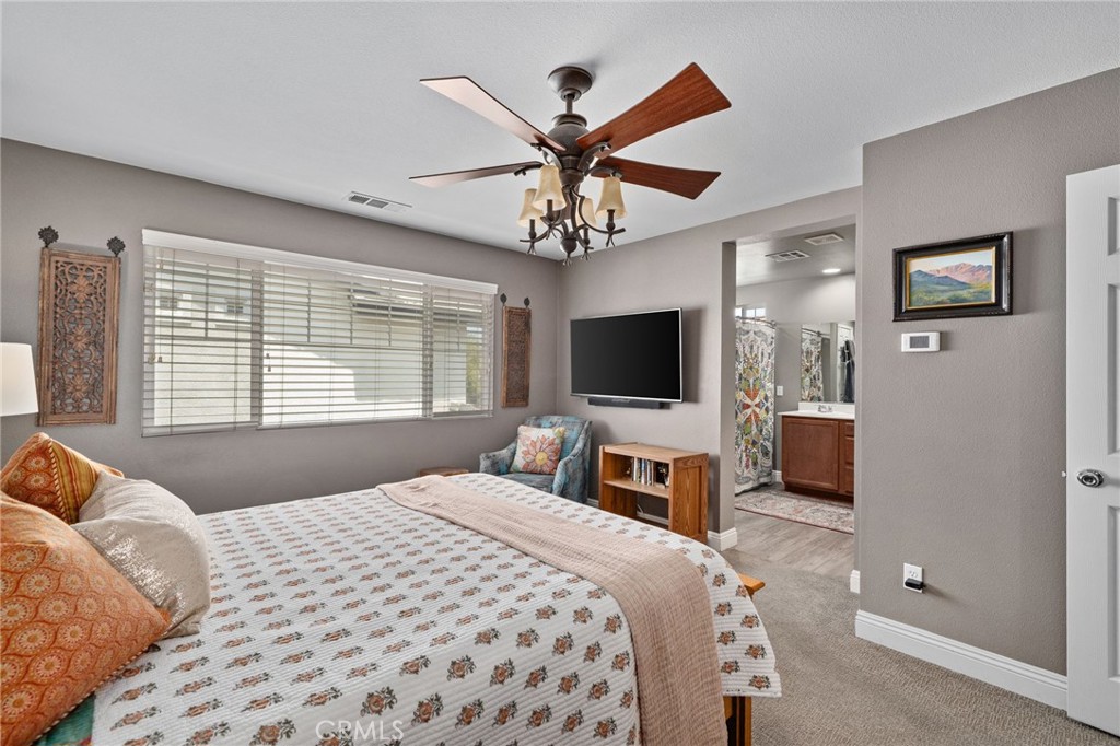 33942 Telstar Road Yucaipa, CA 92399 - Photo 18 of 40 a bedroom with a bed and a flat screen tv
