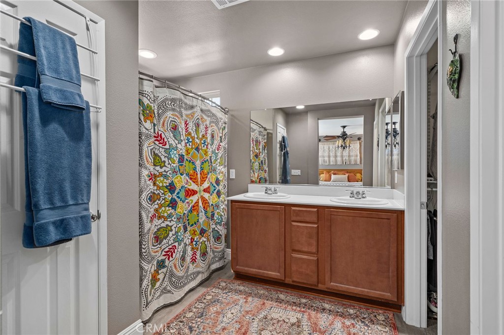 33942 Telstar Road Yucaipa, CA 92399 - Photo 20 of 40 a bathroom with a sink a vanity and a shower