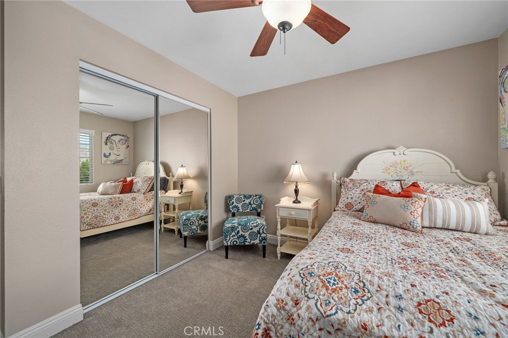 33942 Telstar Road Yucaipa, CA 92399 - Photo 23 of 40 a bedroom with bed and a chandelier