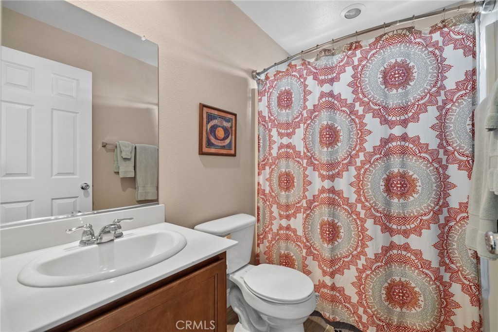 33942 Telstar Road Yucaipa, CA 92399 - Photo 27 of 40 a bathroom with a toilet sink and mirror