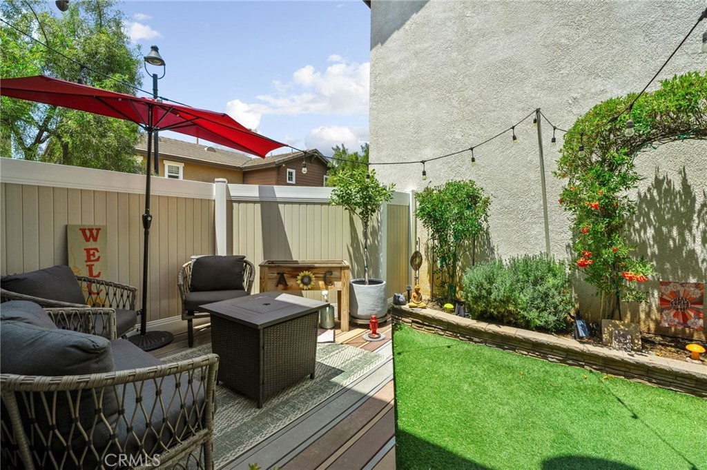 33942 Telstar Road Yucaipa, CA 92399 - Photo 29 of 40 a view of a deck with couches table and chairs under an umbrella