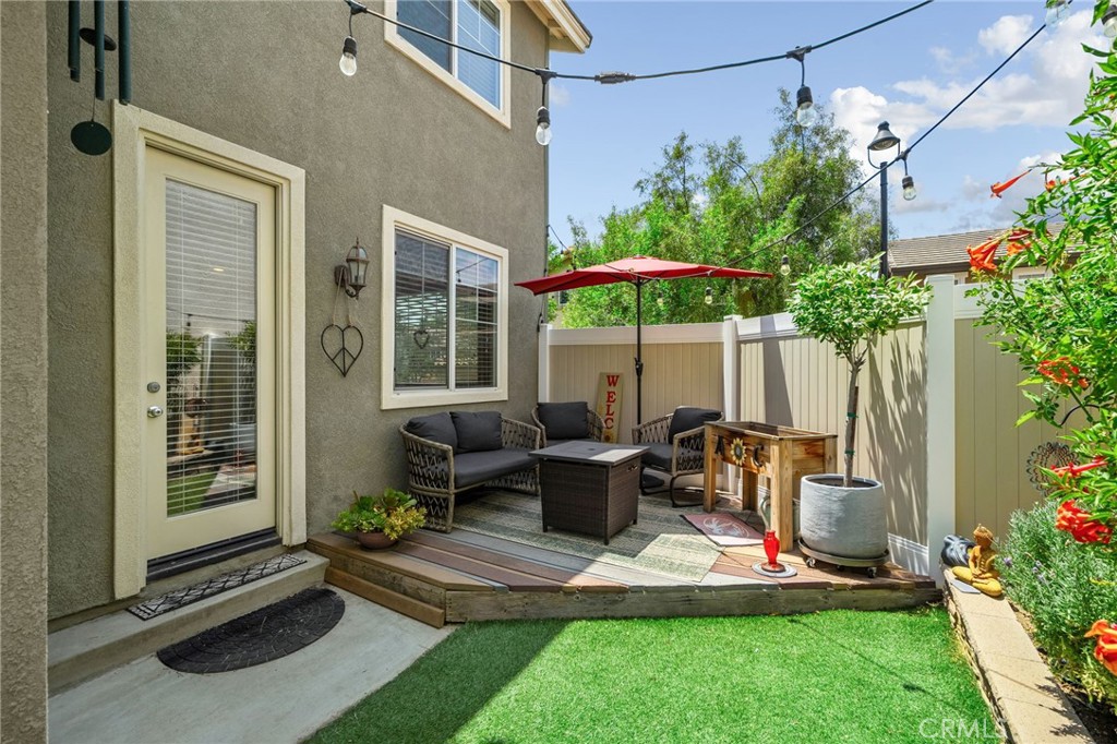 33942 Telstar Road Yucaipa, CA 92399 - Photo 32 of 40 a backyard of a house with table and chairs under an umbrella