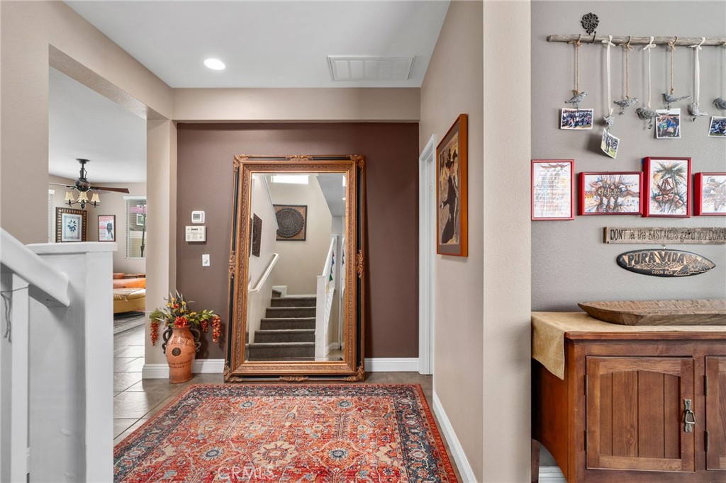 33942 Telstar Road Yucaipa, CA 92399 - Photo 5 of 40 a view of a hallway with workspace and mirror