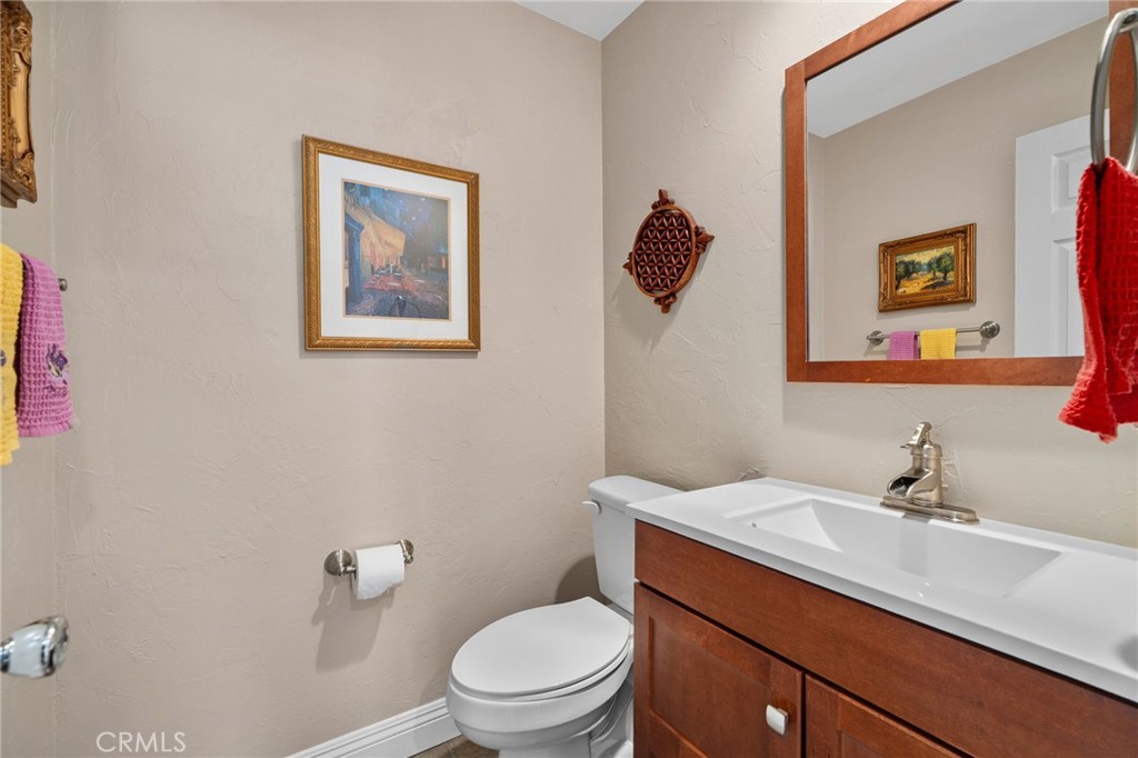 33942 Telstar Road Yucaipa, CA 92399 - Photo 9 of 40 a bathroom with a toilet a sink and mirror