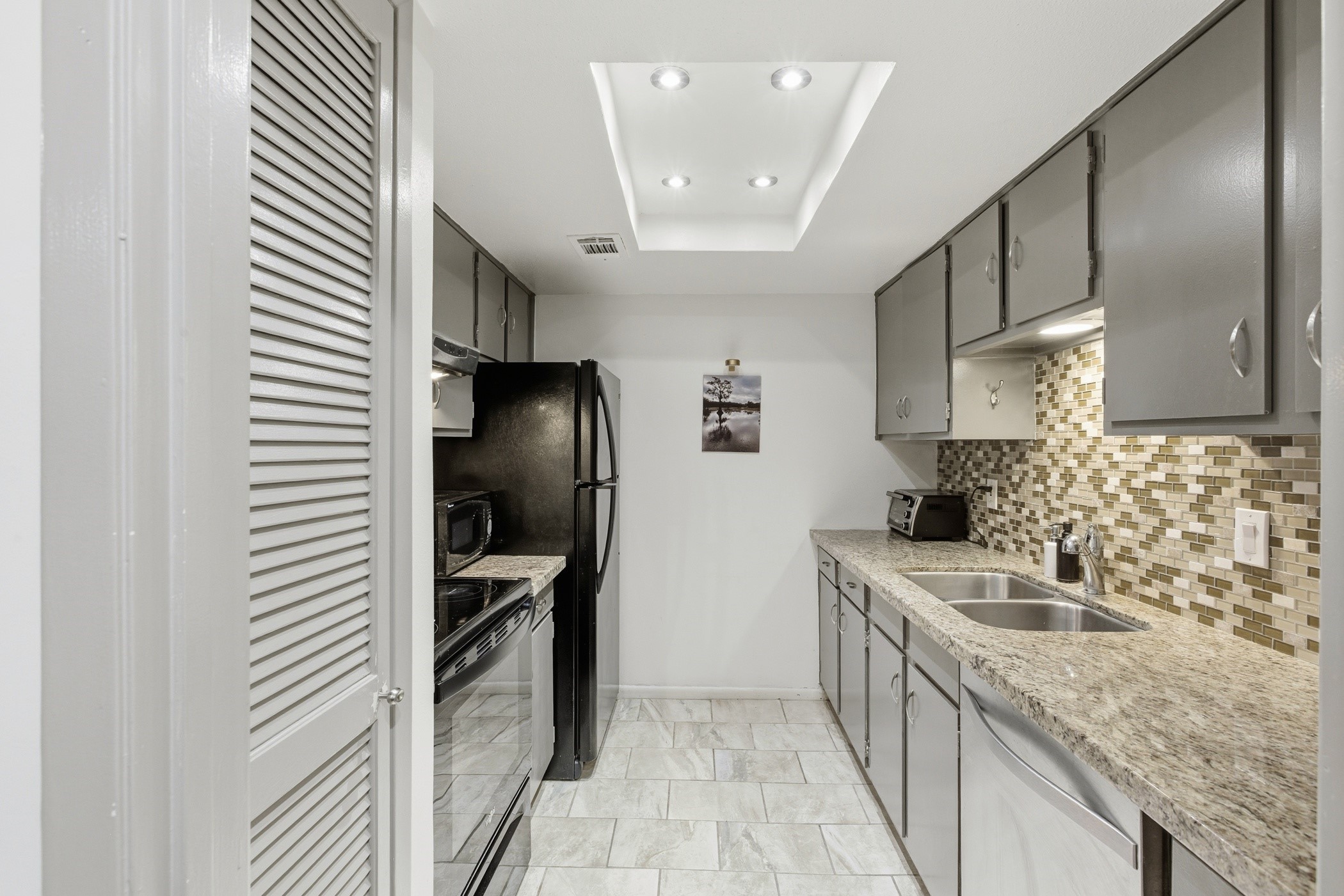 2224 South Piney Point Road, Unit 222 Houston, TX 77063 - Photo 13 of 28 a kitchen with a sink stove and refrigerator