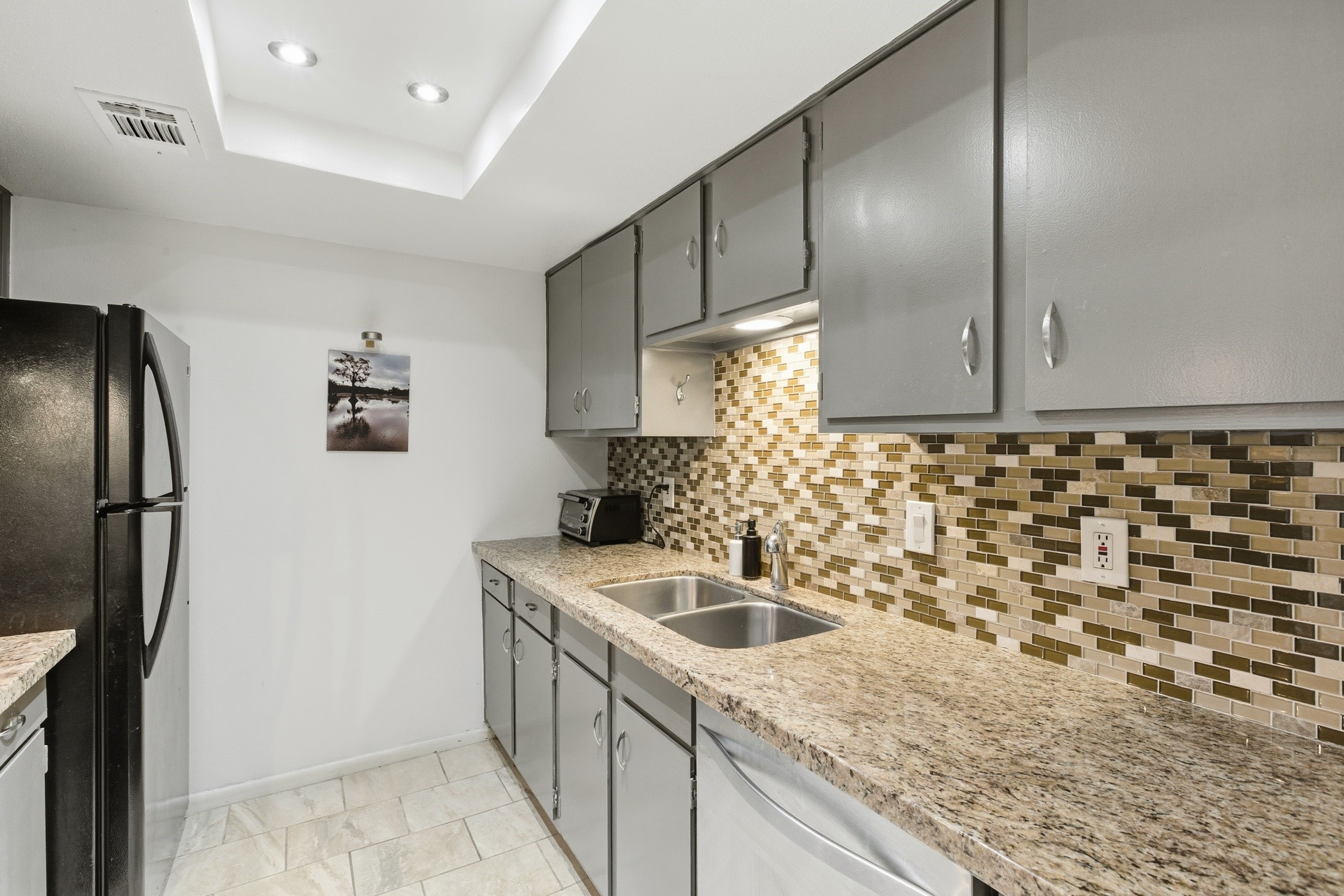 2224 South Piney Point Road, Unit 222 Houston, TX 77063 - Photo 14 of 28 a kitchen with stainless steel appliances granite countertop a sink stove and refrigerator