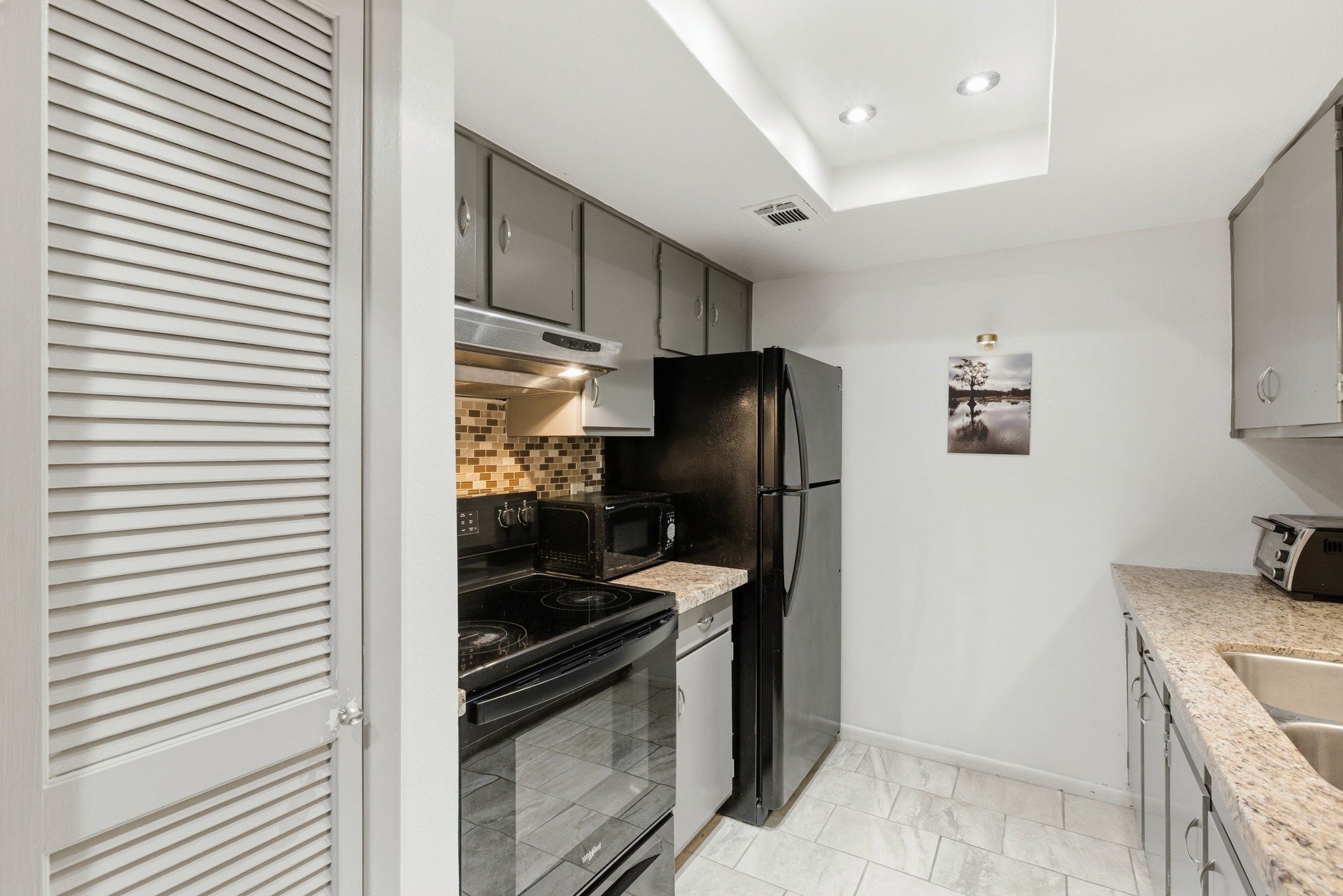2224 South Piney Point Road, Unit 222 Houston, TX 77063 - Photo 15 of 28 a kitchen with a refrigerator and a stove