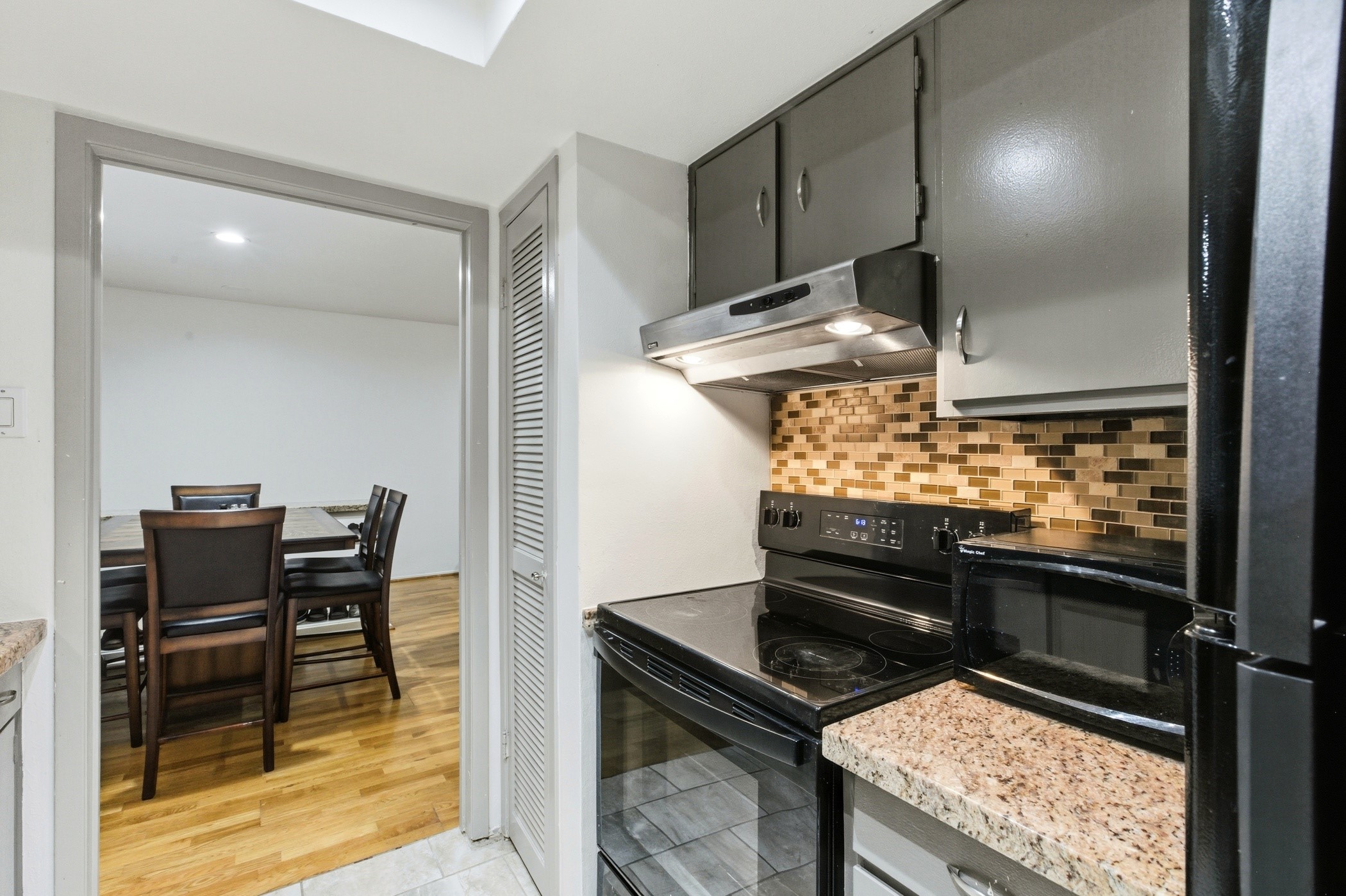 2224 South Piney Point Road, Unit 222 Houston, TX 77063 - Photo 17 of 28 a kitchen view of a stove and a refrigerator