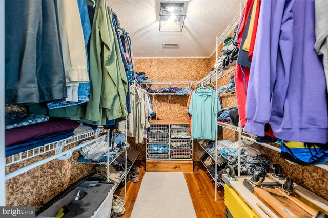 a view of a closet with furniture and a rug
