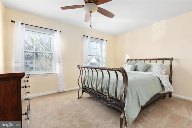 a bed sitting in a room next to a window