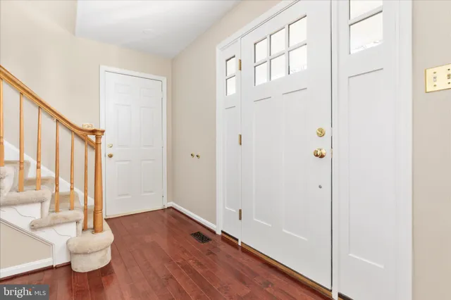 a view of an entryway with wooden floor
