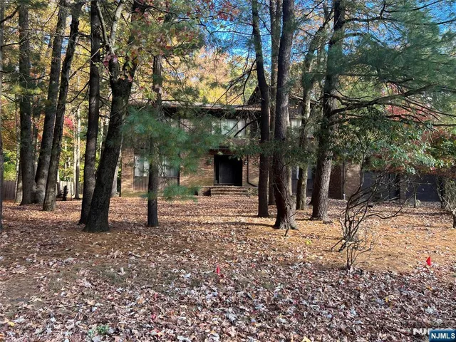 a view of a house with trees in the background