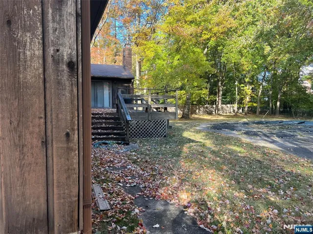 a view of a porch with furniture and a yard