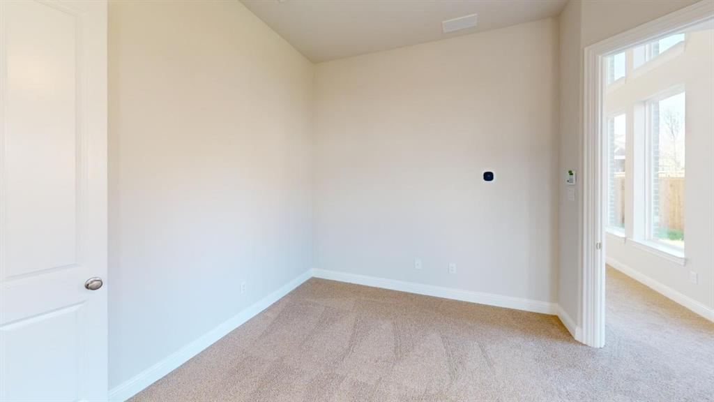 8407 Cornerstone Drive Rowlett, TX 75088 - Photo 9 of 25 Neutral-toned interior room featuring light beige walls and carpeting