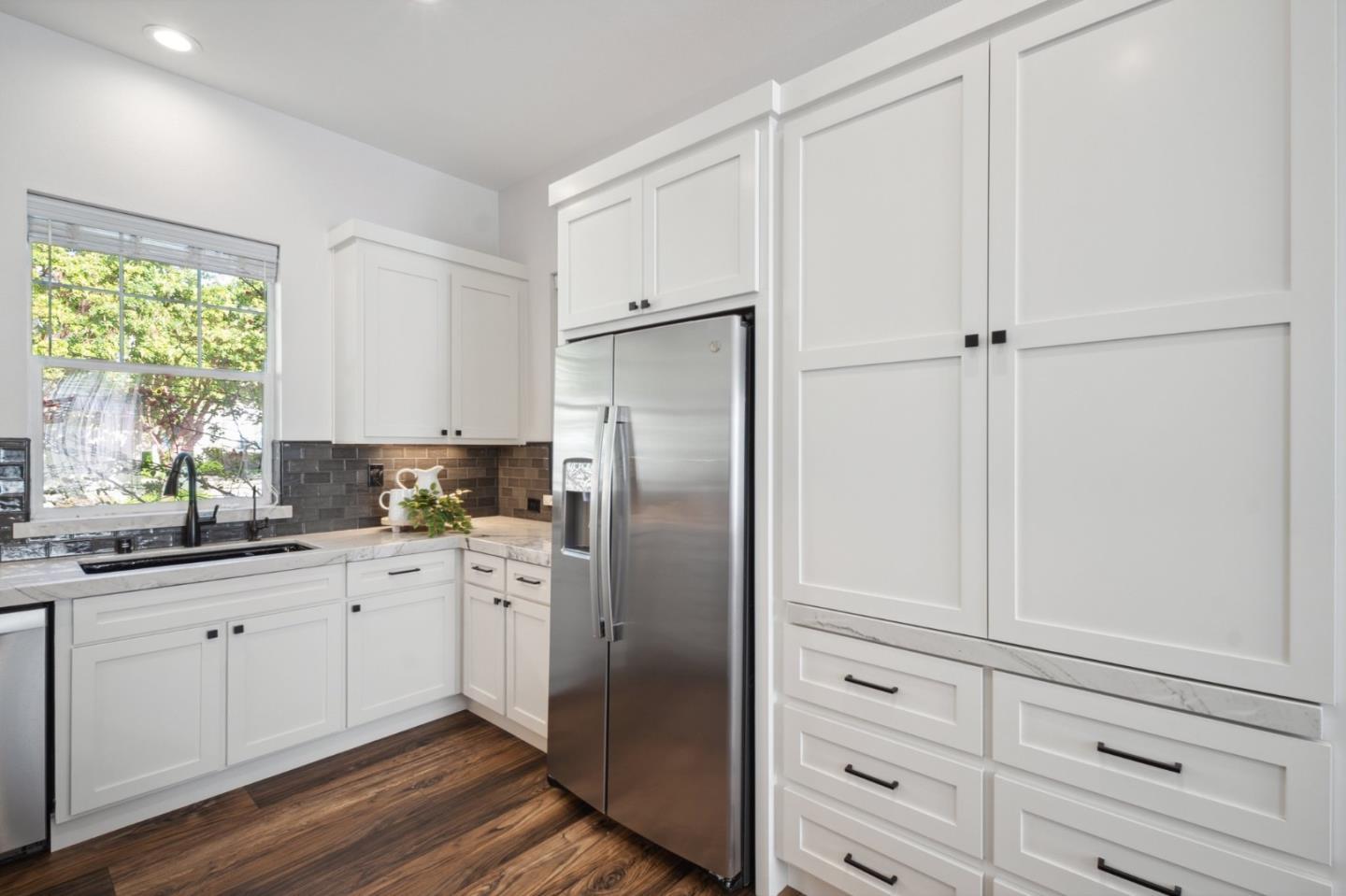 7531 Edinburgh Way Gilroy, CA 95020 - Photo 15 of 52 a kitchen with cabinets stainless steel appliances and a window