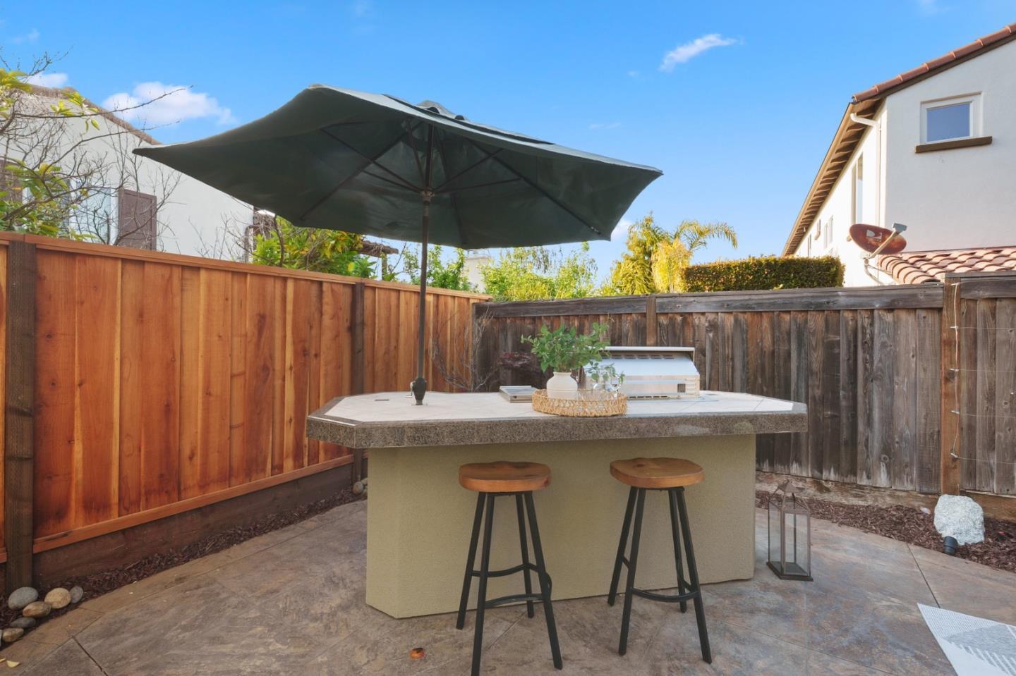 7531 Edinburgh Way Gilroy, CA 95020 - Photo 34 of 52 a view of table and chair under an umbrella