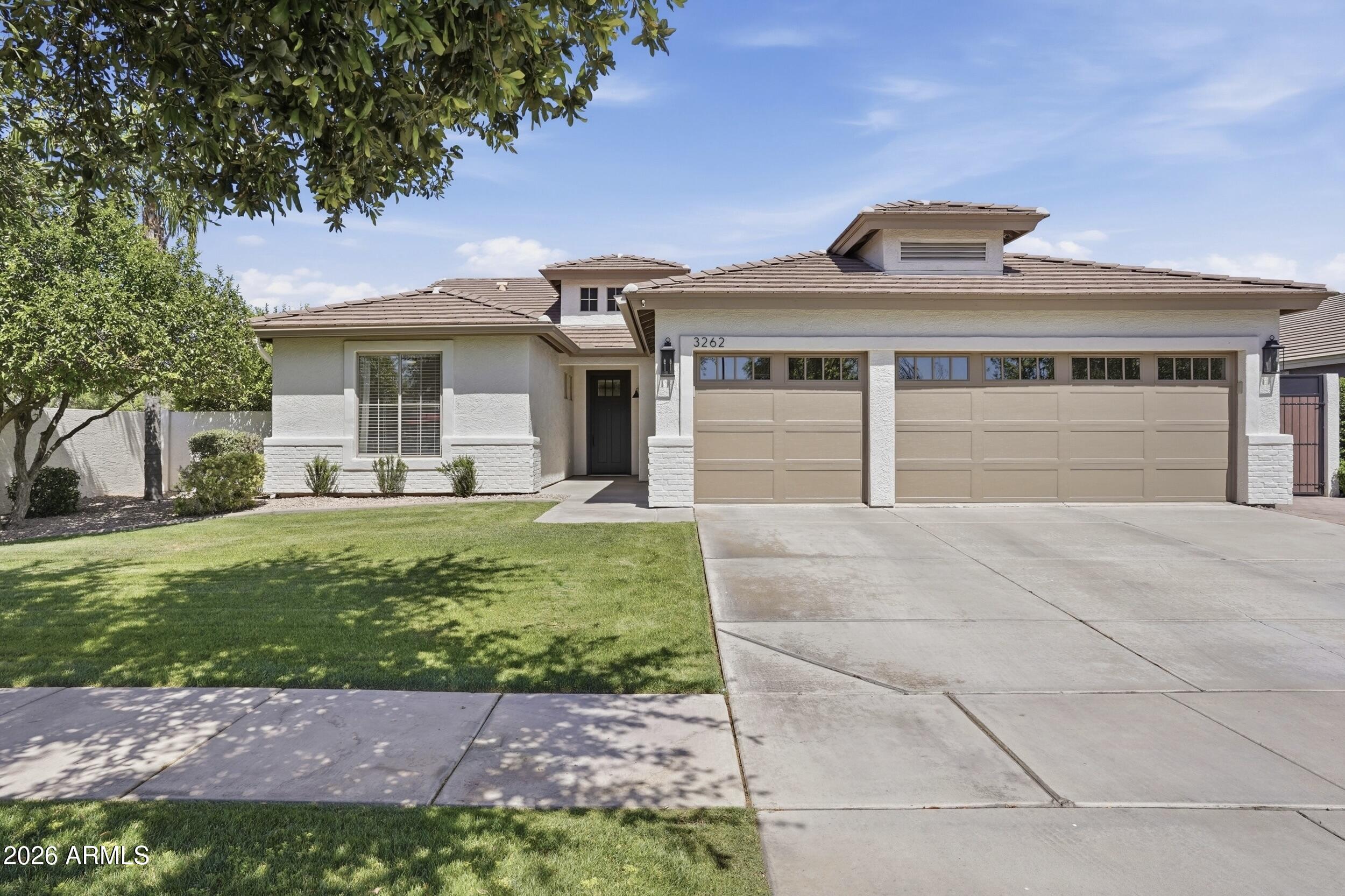 3262 East Cotton Lane Gilbert, AZ 85234 - Photo 1 of 53 a front view of a house with a garden