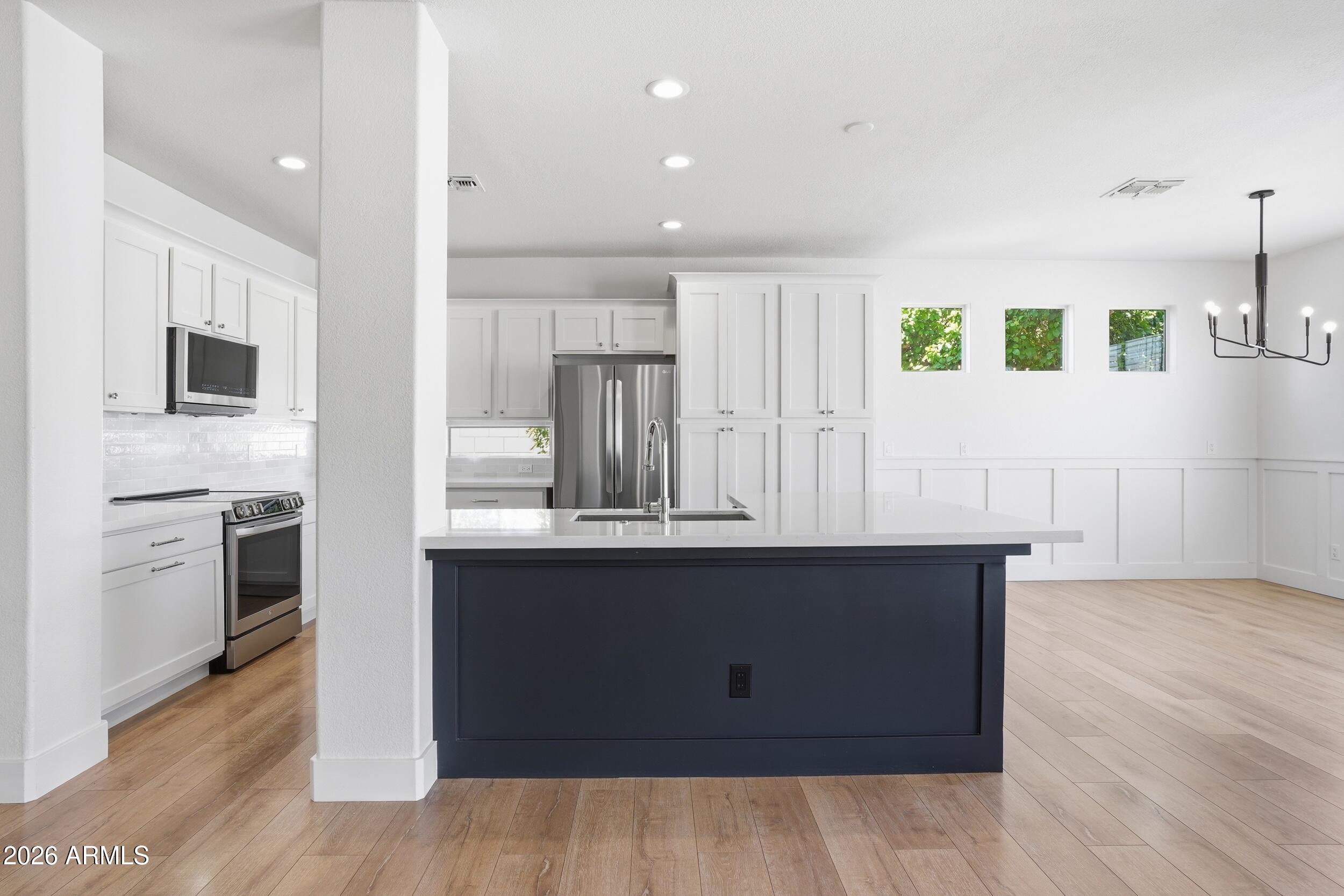 3262 East Cotton Lane Gilbert, AZ 85234 - Photo 11 of 53 a kitchen with kitchen island sink stove and refrigerator