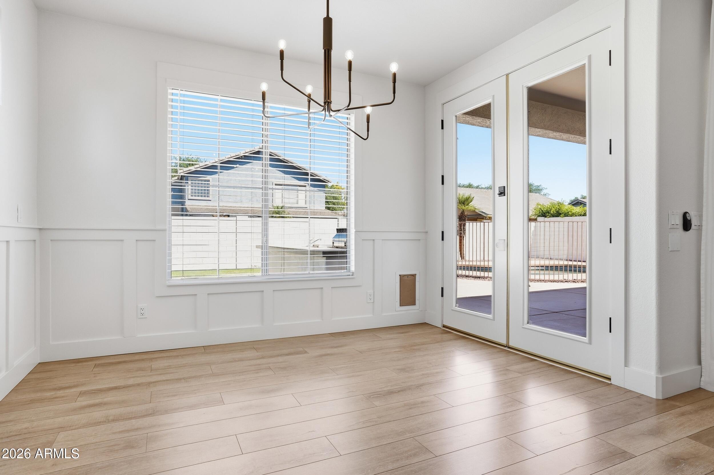 3262 East Cotton Lane Gilbert, AZ 85234 - Photo 16 of 53 an empty room with wooden floor and windows